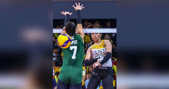 University of Santo Tomas Golden Tigresses’ Jonna Perdido hammered the ball over the defense of De La Salle University Lady Spikers’ Shevana Laput. UAAP PHOTO