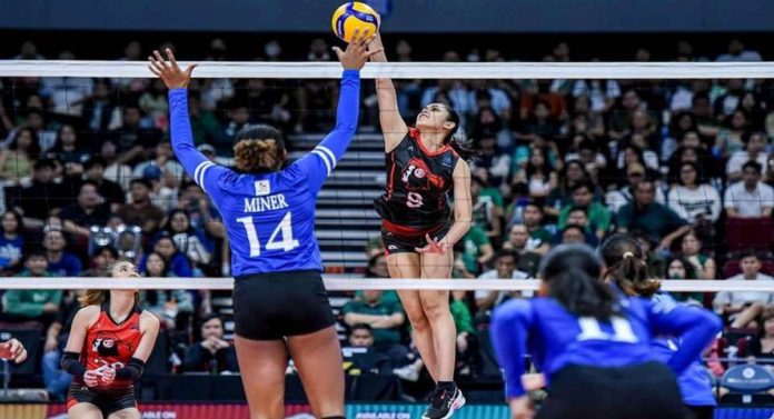 University of the East Lady Red Warriors’ Casiey Dongallo attempts to score against the defense of Ateneo de Manila University Blue Eagles’ Alexa Miner. UAAP PHOTO