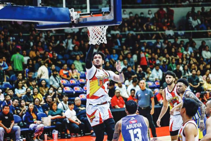 San Miguel Beermen’s June Mar Fajardo goes for a one-hander against the defense of Magnolia Chicken Timplados Hotshots’ Calvin Abueva. PBA PHOTO