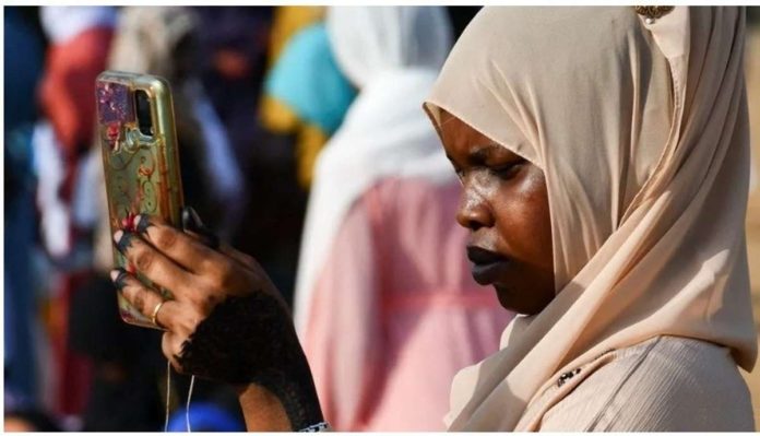 A woman checks her mobile phone. Some Sudanese telecom providers have been experiencing signal problems. REUTERS