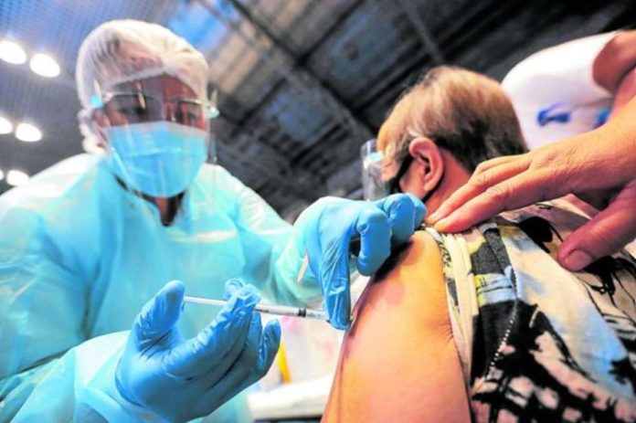 A nurse vaccinates a senior citizen against coronavirus disease 2019. INQUIRER FILE PHOTO