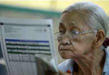 An elderly woman checks her ballot paper in this undated election photo. Last year, the Commission on Elections had a test run of earlier voting for senior citizens, persons with disabilities, and pregnant women in some areas. AFP/GETTY IMAGES