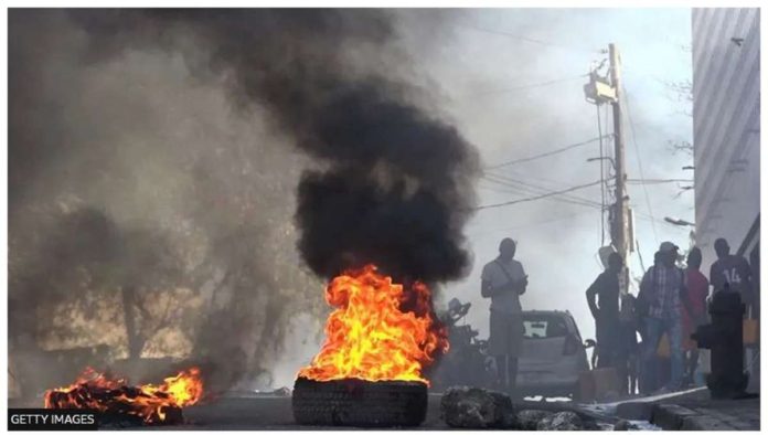 Tires are set on fire outside the main prison in the Haitian capital, Port-au-Prince. GETTY IMAGES