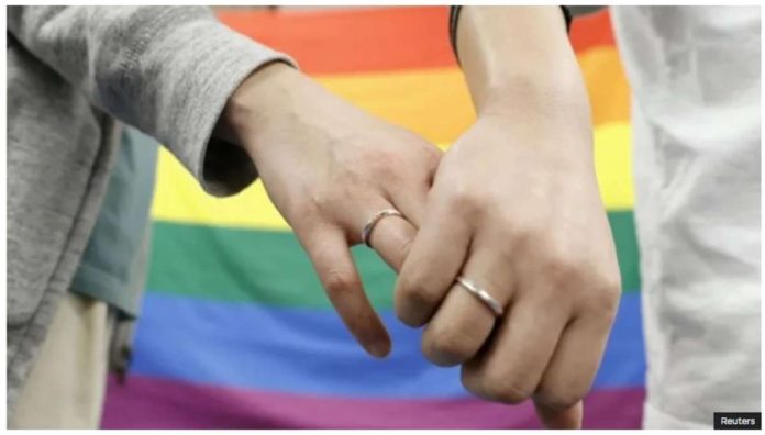 Plaintiffs hold hands after a district court ruled on the legality of same-sex marriages outside Sapporo district court in Sapporo, Japan. REUTERS