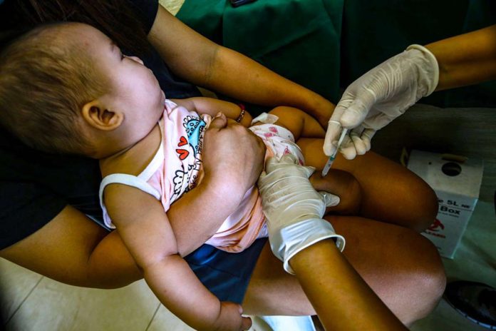 A toddler receives a pentavalent vaccine, which will protect her against diptheria, tetanus, pertussis, influenza type B and hepatitis B, at a health center in Barangay Pinyahan, Quezon City on March 22, 2024. The city government has declared an outbreak of pertussis (whooping cough) after 23 cases and four deaths, mostly infants, from January to March 20. PNA