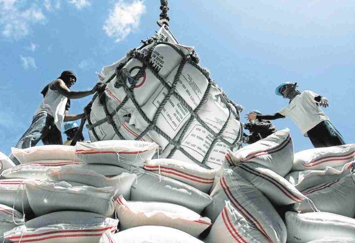 Sacks of Imported rice from Vietnam are being unloaded in Surigao City port. INQUIRER.NET FILE PHOTO