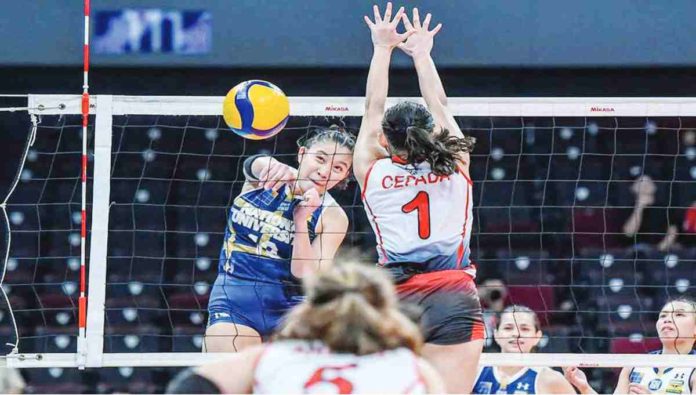 Negrense Arah Panique of National University Lady Bulldogs scores against the defense of University of the East Lady Warriors’ Khy Cepada. UAAP PHOTO