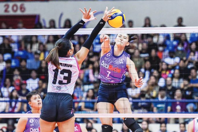 Choco Mucho Flying Titans’ Madeleine Madayag smashes the ball towards the defense of Akari Power Chargers’ Celine Domingo. PVL PHOTO