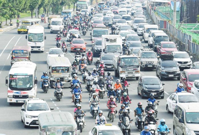 Motorists and vehicles travel along a road amid traffic jam in Manila on November 24, 2023. PHOTO BY TED ALJIBE / AFP