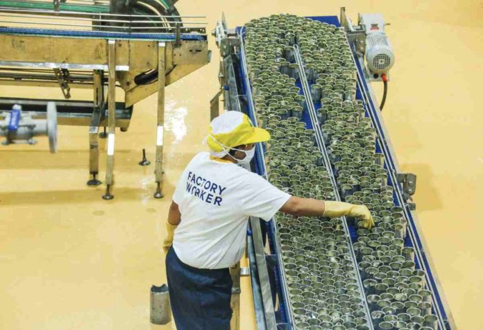 Employees process cans of sardines at a manufacturing plant in Sto. Tomas, Batangas. JONATHAN CELLONA/ABS-CBN NEWS PHOTO