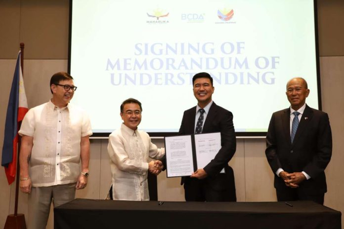 Maharlika Investment Corp. (MIC) president/CEO Rafael Consing Jr. and Bases Conversion and Development Authority (BCDA) counterpart Joshua Bingcang (2nd and 3rd from left) sign agreements in Taguig City on Monday, April 29, to explore investments within BCDA properties. Witnessing the signing are Finance Secretary and MIC chair Ralph Recto (left) and BCDA chair Delfin Lorenzana. BCDA PHOTO