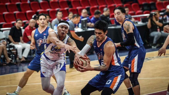 Magnolia Chicken Timplados Hotshots' Jerrick Balanza and Meralco Bolts' Raymond Almazan battle for the rebound. PBA PHOTO