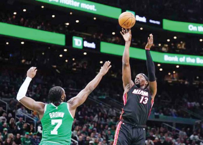 Miami Heat’s Bam Adebayo (13) shoots against the defense of Boston Celtics’ Jaylen Brown (7). PHOTO COURTESY OF DAVID BUTLER II-USA TODAY SPORTS