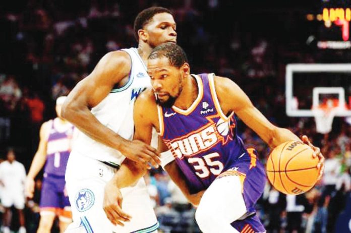 Phoenix Suns’ Kevin Durant drives to the basket against Minnesota Timberwolves’ Anthony Edwards. PHOTO BY DAVID BERDING/GETTY IMAGES