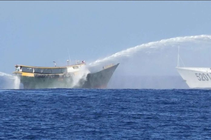 Philippine resupply vessel Unaizah May 4 (left) is hit by two Chinese coast guard water cannons as they tried to enter the Second Thomas Shoal, locally known as Ayungin Shoal, in the disputed South China Sea on March 5, 2024. For the first time, China has publicized what it claims is an unwritten 2016 agreement with the Philippines over access to South China Sea islands. AP PHOTO/AARON FAVILA, FILE