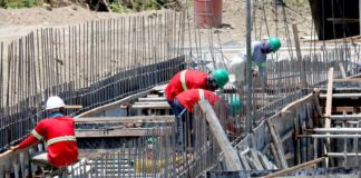 Construction workers perform their tasks for a road project in Imus, Cavite. They are protected by hard hats and long-sleeved garments but must limit sun exposure between 10 a.m. and 4 p.m. when ultraviolet rays are strongest. President Ferdinand Marcos Jr. has ordered the Regional Tripartite Wages and Productivity Boards to initiate a timely review of the minimum wage rates. PNA