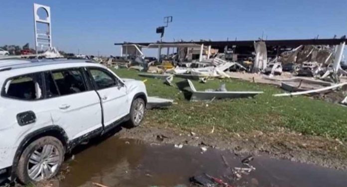 A car sits in a pile of debris after major storms through Texas. BBC