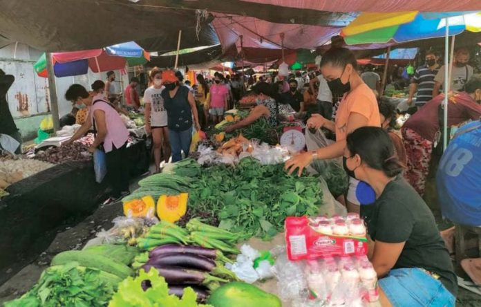 Photo shows people at a market. PN FILE PHOTO