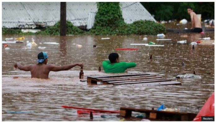 People wade through flooded streets in Encantado, Rio Grande do Sul state, southern Brazil. The municipality of Encantado has turned into a river, as residents have been desperately trying to move to higher ground. Reuters