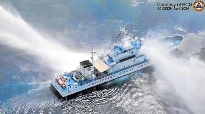 A frame grab from video footage released by the Philippine Coast Guard shows its ship, the BRP Bagacay, being hit by water cannon from Chinese coast guard vessels near the Chinese-controlled Scarborough Shoal in the West Philippine Sea on April 30, 2024. Also hit on its way to the shoal was the BRP Bankaw of the Bureau of Fisheries and Aquatic Resources. AFP