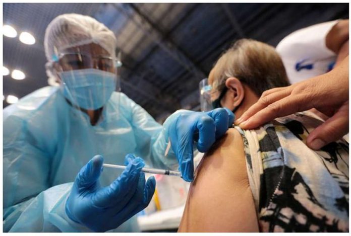 A nurse injects a senior citizen with the Russian-made Sputnik V vaccine at the Makati Coliseum. INQUIRER file photo / GRIG C. MONTEGRANDE