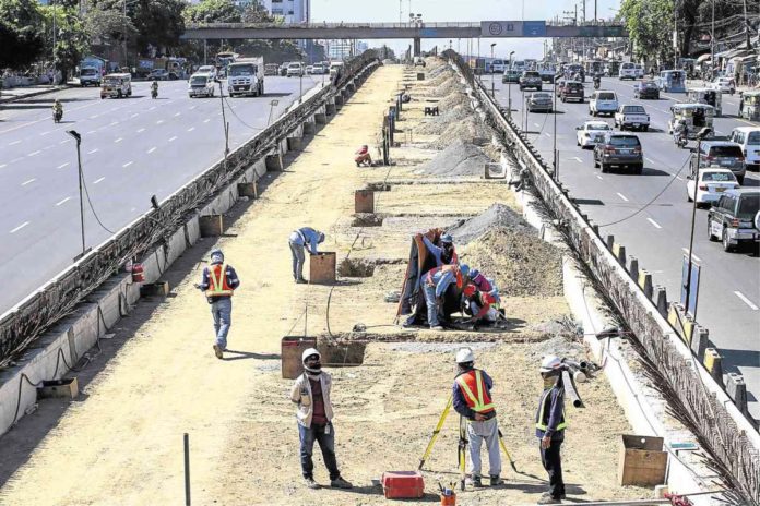 Workers continue to build the Metro Rail Transit Line even under the scorching heat of the sun. JAM STA. ROSA/FILE PHOTO