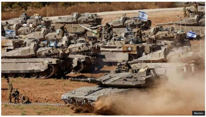 Israeli military tanks are positioned near the Gaza Strip. REUTERS