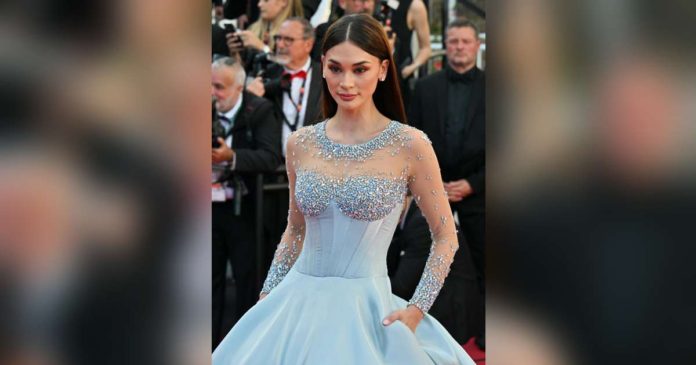 Pia Wurtzbach wears a custom-made blue Michael Cinco liquid satin gown at one of the events at Cannes. CELEBMAFIA.COM PHOTO