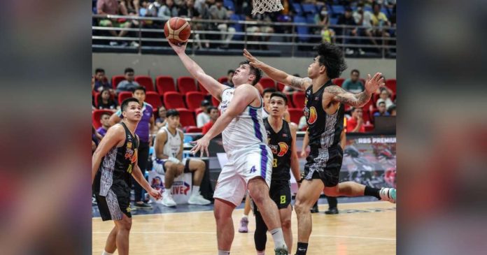 Converge FiberXers’ Patrick Maagdenberg evades the defense of TNT Tropang Giga’s Glenn Khobuntin for a reverse basket. PBA PHOTO