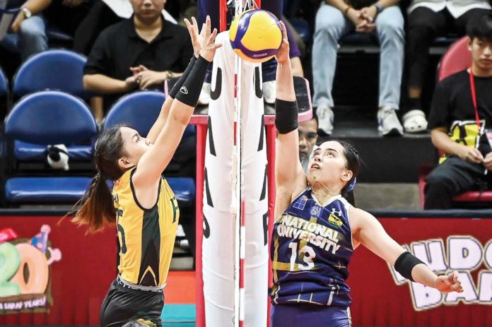 Guimarasnon Camille Lamina of the National University Lady Bulldogs attempts to drop the ball against Far Eastern University Lady Tamaraws’ Gerzel Petallo. UAAP PHOTO