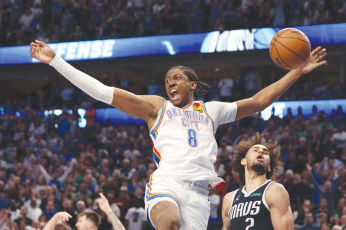 Oklahoma City Thunder's Jalen Williams loses handle of the ball after driving past the defense of Dallas Mavericks' Dereck Lively II. PHOTO BY TIM HEITMAN/GETTY IMAGES