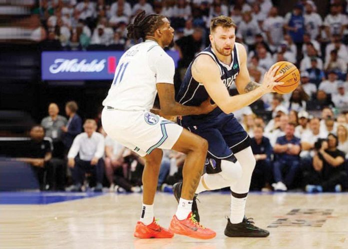 Dallas Mavericks; Luka Doncic attempts to blow past the defense of Minnesota Timberwolves’ Naz Reid. PHOTO COURTESY OF SPORTSKEEDA