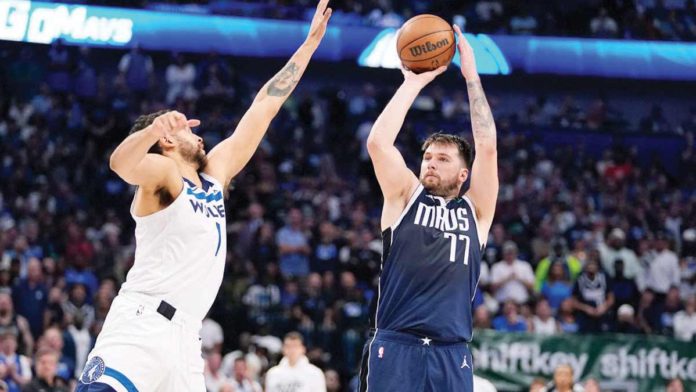 Dallas Mavericks’ Luka Doncic pulls up for a shot against the defense of Minnesota Timberwolves' Kyle Anderson. AP PHOTO