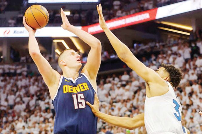 Denver Nuggets’ Nikola Jokić attempts a one-hander shot against Minnesota Timberwolves' Karl-Anthony Towns. PHOTO COURTESY OF SPORTSKEEDA