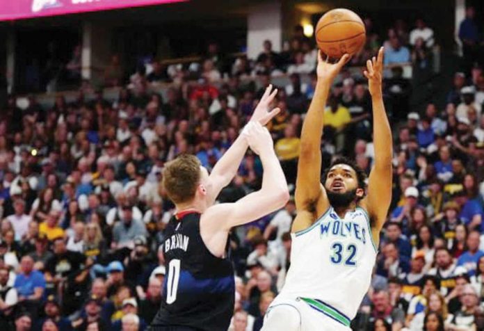 Minnesota Timberwolves’ Karl-Anthony Towns shoots over the defense of Denver Nuggets’ Christian Braun. PHOTO BY ROD CHENOY/USA TODAY SPORTS