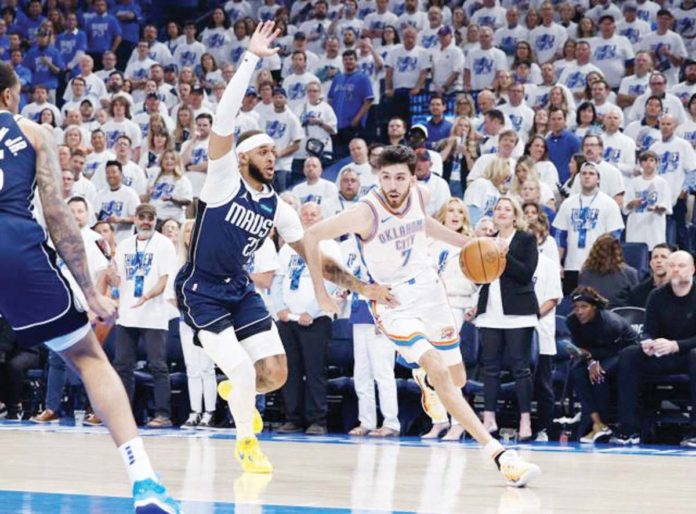 Oklahoma City Thunder’s Chet Holmgren (7) moves around Dallas Mavericks' Daniel Gafford (21). PHOTO COURTESY OF ALONZO ADAMS/USA TODAY SPORTS