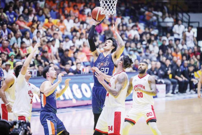 Meralco Bolts’ Raymond Almazan easily scores against the defense of Barangay Ginebra San Miguel Kings’ Christian Standhardinger. PBA PHOTO