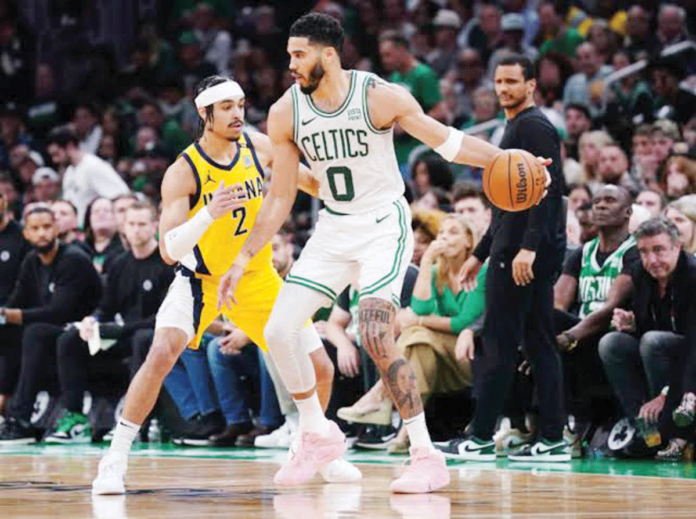 Boston Celtics’ Jayson Tatum (0) moves the ball against the defense of Indiana Pacers’ Andrew Nembhard (2). PHOTO BY DAVID BUTLER II/USA TODAY SPORTS