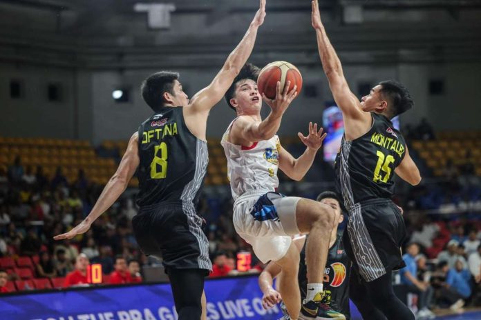 Rain or Shine Elasto Painters’ Adrian Nocum splits the defense of TNT Tropang Giga’s Calvin Oftana and Kib Montalbo for an inside hit. PBA PHOTO