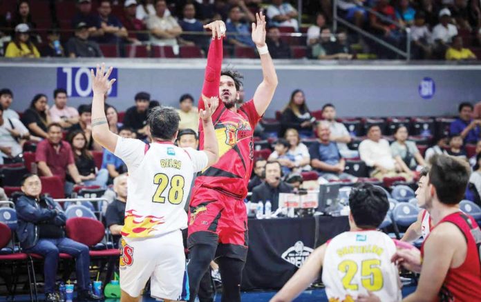 San Miguel Beermen’s June Mar Fajardo pulls up for a shot against the defense of Rain or Shine Elasto Painters’ Beau Belga. PBA PHOTO