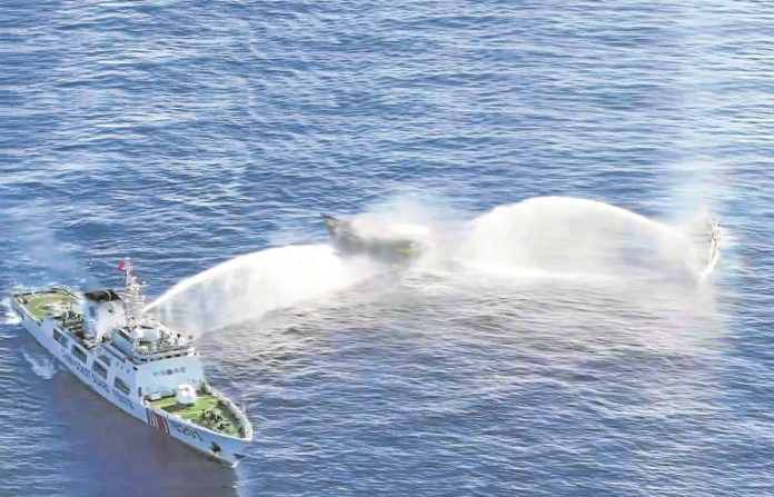 Manila has asked Beijing to order all its vessels to leave Ayungin Shoal following the “dangerous maneuvers” made by the China Coast Guard to block Philippine ships headed for the BRP Sierra Madre on March 5, 2024. An image from aerial footage released by the Philippine Coast Guard shows two CCG vessels blasting their water cannons at Unaizah on May 4. AFP