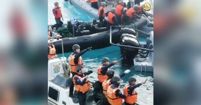 China Coast Guard personnel brandish bolos against Philippine navy personnel during the June 17, 2024 resupply mission in a naval outpost in Ayungin (Second Thomas) Shoal. PHOTO FROM THE AFP