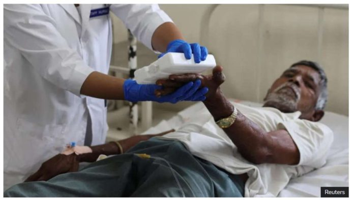 A nurse gives treatment to a 76-year-old patient of heat exhaustion inside a Heat Illness ward of a government hospital during a heatwave in Ahmedabad, India. REUTERS