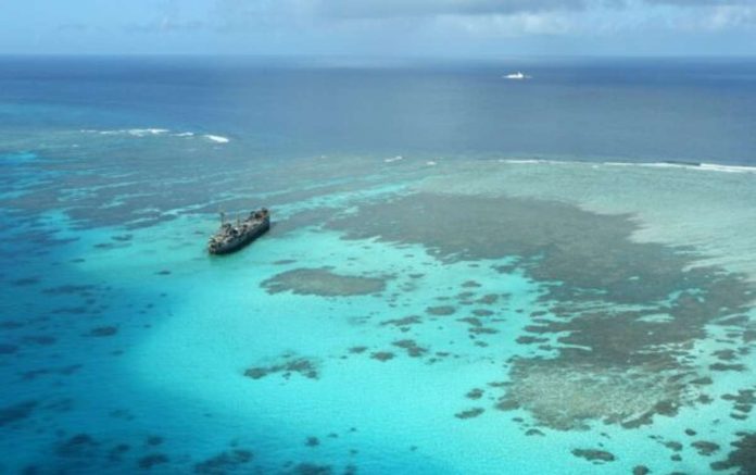 The BRP Sierra Madre, a Navy warship that now serves as a military outpost, keeps watch over Ayungin (Second Thomas), located within the country’s exclusive economic zone. Nearby are Chinese coast guard and militia vessels in this shot taken on February 21, 2023, during an aerial surveillance by the Philippine Coast Guard. PHILIPPINE DAILY INQUIRER, NIÑO JESUS ORBETA