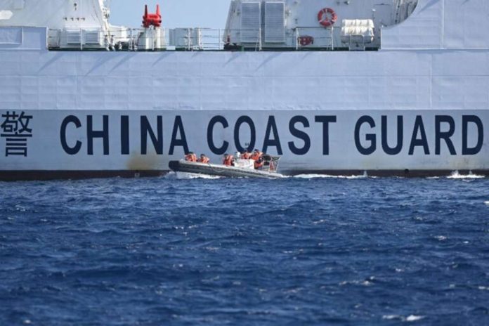 A rigid hull inflatable boat leaves a China Coast Guard ship near the China-controlled Scarborough Shoal, in disputed waters of the South China Sea on February 16, 2024. A China Coast Guard vessel “intentionally rammed” a Philippine Coast Guard boat transporting a sick member of the Philippine Navy from Ayungin (Second Thomas) Shoal on May 19, 2024, according to Commodore Jay Tarriela, PCG spokesperson for the West Philippine Sea. PHOTO BY TED ALJIBE / AFP