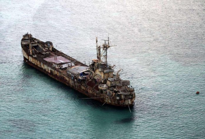 This aerial photograph taken from a military aircraft shows the dilapidated Sierra Madre ship of the Philippine Navy anchored near Ayungin shoal (Second Thomas Shoal) with Philippine soldiers on-board to secure the perimeter in the Spratly group of islands in the South China Sea, west of Palawan. AFP