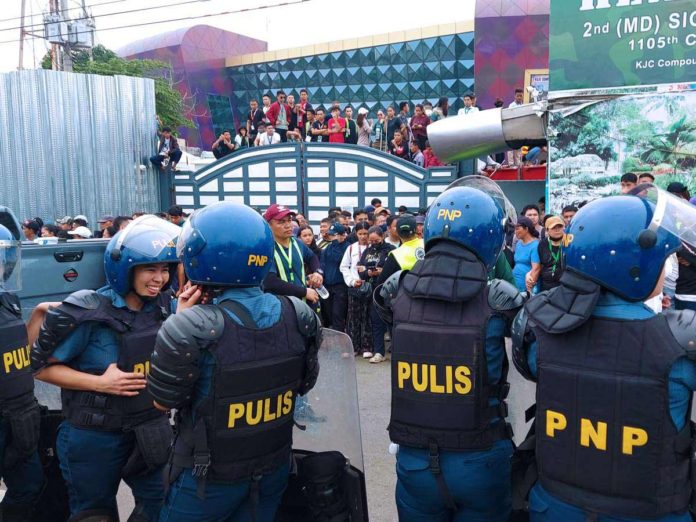 Various units from the Philippine National Police swoop down on the Kingdom of Jesus Christ compound in Davao City on June 10. They attempted to serve the arrest warrant for child abuse and human trafficking charges to the church’s leader, Apollo Quiboloy, but they did not find him. PNA