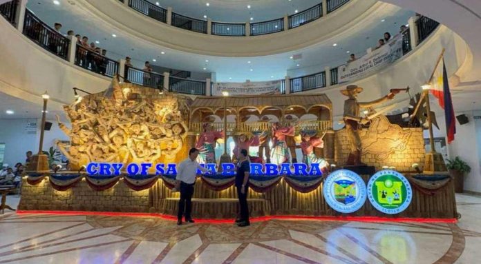 Gov. Arthur Defensor Jr. of Iloilo Province and Mayor Dennis Superficial of Santa Barbara town inaugurate the display of the “Cry of Santa Barbara” float with a ceremonial illumination at the Iloilo Provincial Capitol lobby. IME SORNITO/PN