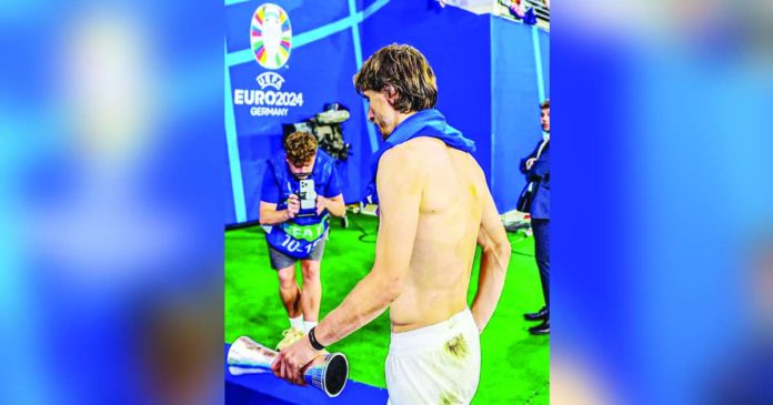 Croatia’s Luka Modric walks off the court with his Player of the Game trophy after being held to 1-1 draw by Italy. PHOTO FROM FABRIZIO ROMANO’S FACEBOOK PAGE