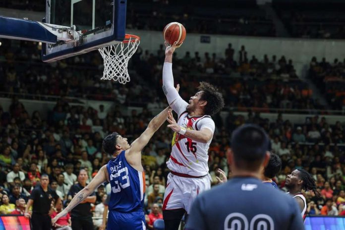 San Miguel Beermen’s June Mar Fajardo towers over the defense of Meralco Bolts’ Brandon Bates for an inside hit. PBA PHOTO